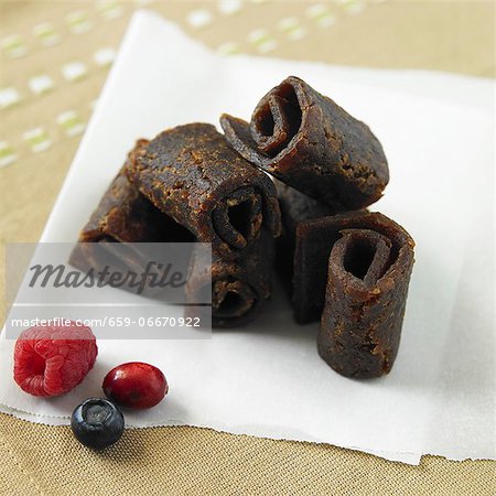 Organic Mixed Berry Fruit Leather on Paper with Fresh Berries