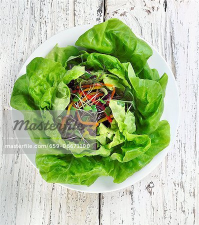 Salad on a White Plate; On a Wooden Table; From Above