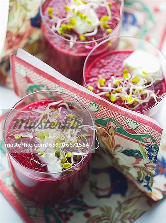 Beetroot juice garnished with shoots and sour cream