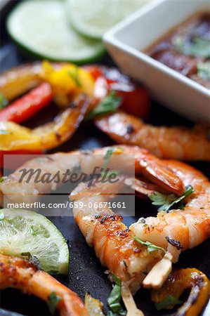 Grilled Shrimp with Limes on a Baking Pan; Dipping Sauce Grilled Shrimp with Limes on a Baking Pan; Dipping Sauce