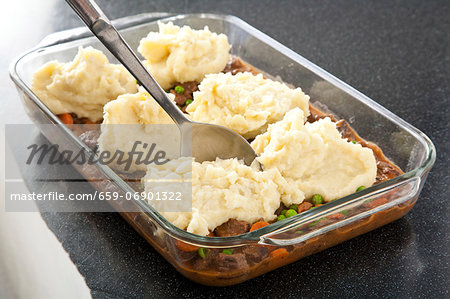 Spooning Mashed Potato Topping onto Shepherds Pie