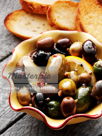 Bowl of Marinated Olives with Slices of Toasted Bread