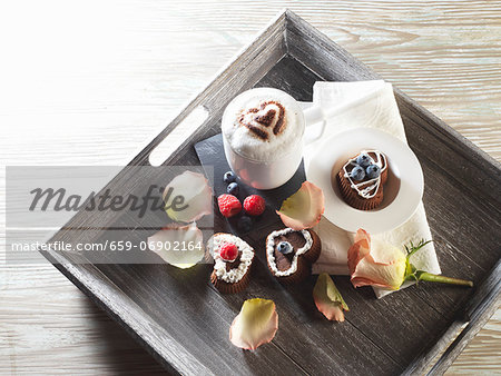 Heart-shaped cupcakes and a cup of cappuccino