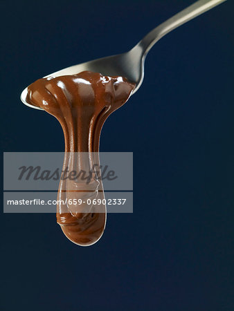 Chocolate flowing from a spoon