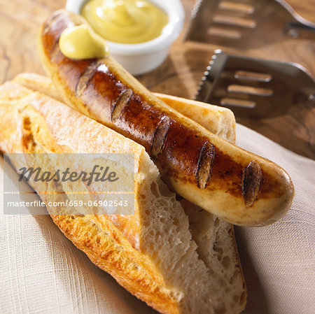 Grilled bratwurst with baguette and mustard Grilled bratwurst with baguette and mustard