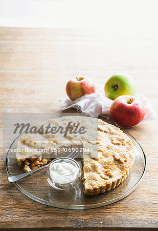 Apple tart with cream, with a large slice removed