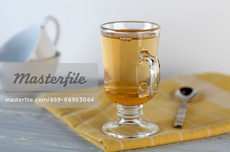 A Glass of Honey Ginger Apple Cider on a Yellow Towel