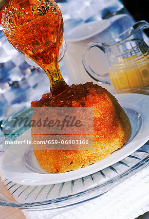 golden syrup poured onto a steamed pudding