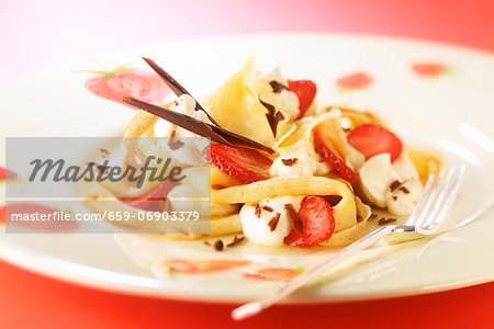 Crêpes with strawberries, cream and chocolate shavings