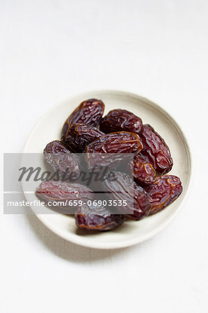 Medjool dates in a small bowl