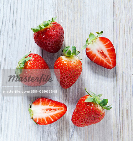 Strawberries on a wooden slab, viewed from above