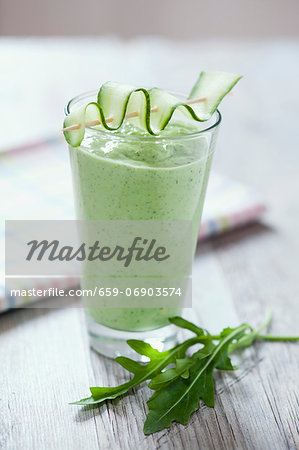 Rocket and cucumber smoothie on a wooden tabletop