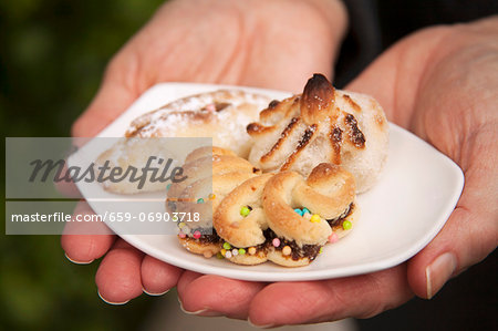 A Woman Holding a Small Dish of Sicilian Almond Pastries