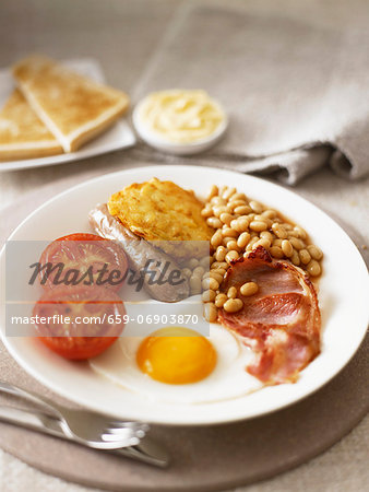 English breakfast with fried egg, bacon and baked beans