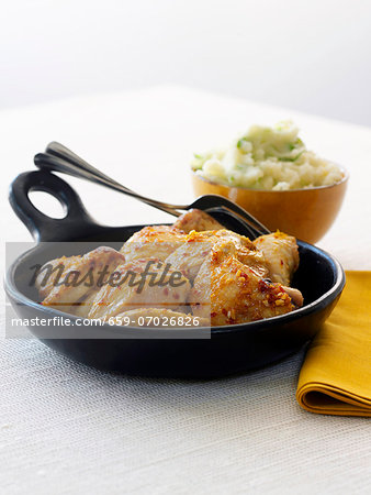 Honey Glazed Chicken in a Cast Iron Skillet; Bowl of Mashed Potatoes in the Background