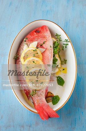 Whole Red Snapper with Fresh Herbs and Lemon; In a Bowl; From Above