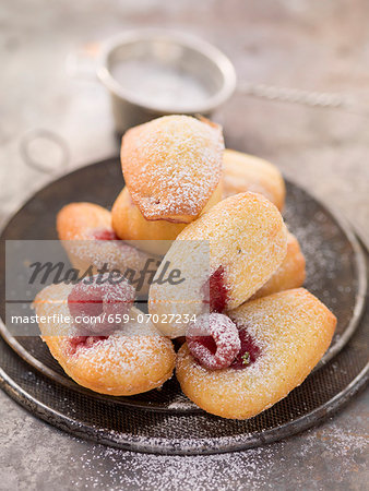 Madeleines with raspberries and icing sugar