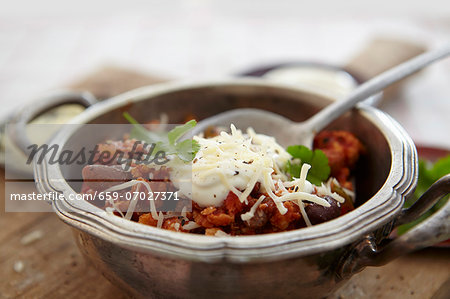 Chicken chilli with sour cream and grated cheese