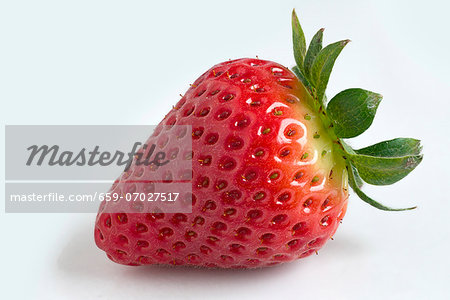 A strawberry against a white background A strawberry against a white background