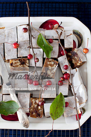 Panforte Squares on a Platter with Berries and a Knife