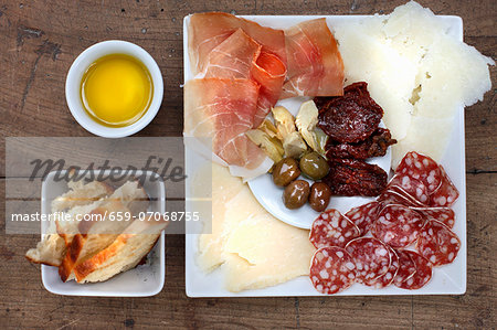 Antipasti: sundried tomatoes, olives, parmesan, Parma ham, olive oil, bread, salami, pickled artichokes Antipasti: sundried tomatoes, olives, parmesan, Parma ham, olive oil, bread, salami, pickled artichokes