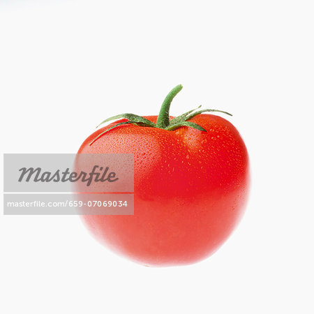 A tomato with drops of water