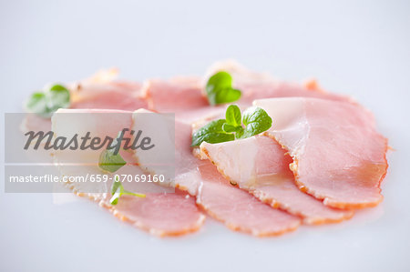 Slices of ham with oregano leaves Slices of ham with oregano leaves