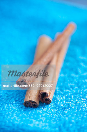 Cinnamon sticks on blue background