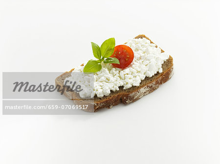 Bread topped with cottage cheese, tomato and basil Bread topped with cottage cheese, tomato and basil