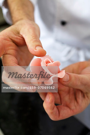 A confectioner shaping a marzipan rose