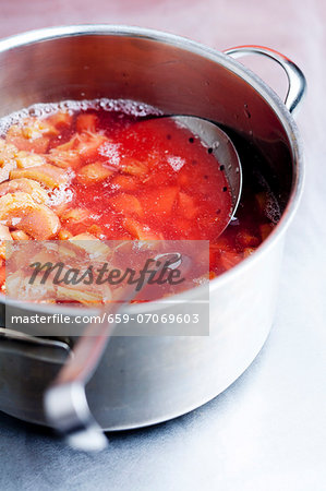 Stewed rhubarb with a skimmer in a saucepan Stewed rhubarb with a skimmer in a saucepan