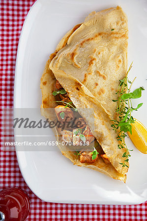 Pancake filled with fried cod, avocado and fresh oregano Pancake filled with fried cod, avocado and fresh oregano
