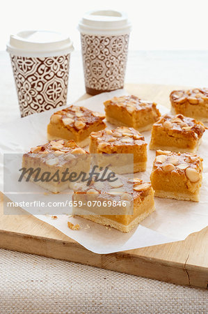 Macadamia nut slices with coffee in takeaway cups