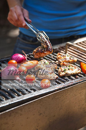 Chicken wings and vegetables on the barbecue Chicken wings and vegetables on the barbecue