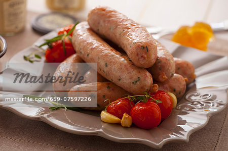 Oven-baked sausages with cherry tomatoes, garlic and thyme Oven-baked sausages with cherry tomatoes, garlic and thyme