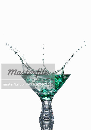Mint liqueur spraying out of the glass Mint liqueur spraying out of the glass