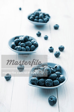 Three small bowls of blueberries