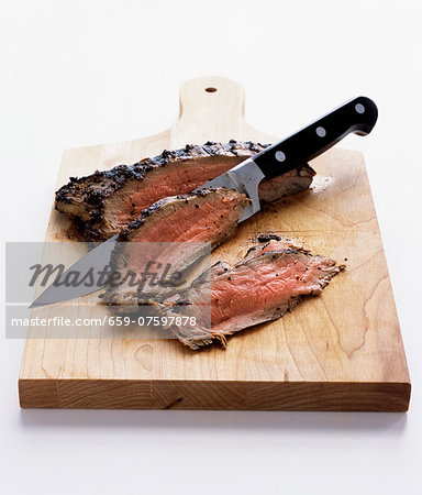 Sliced roast beef on a chopping board Sliced roast beef on a chopping board