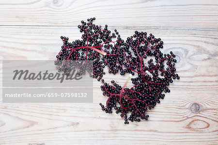 Elderberries on wooden background