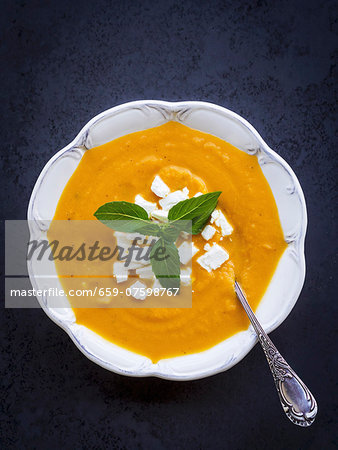 Cream squash soup served with feta cheese.