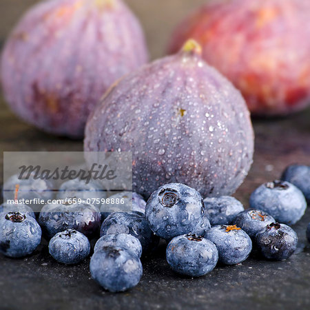 Blueberries and figs with droplets of water