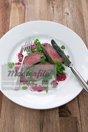 Sliced saddle of venison on green bean salad with beetroot vinaigrette