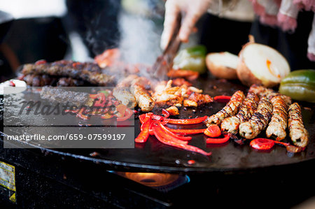Spare ribs, sausages and vegetables on the barbeque