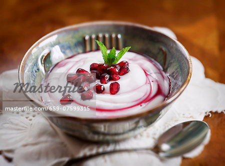 Yoghurt with pomegranate seeds and mint