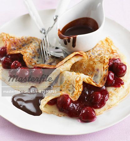 Pancakes with cherries and chocolate sauce