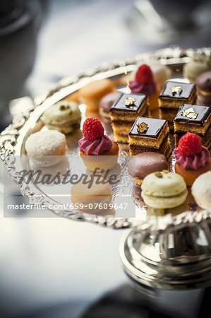 Petit fours on an elegant silver cake stand