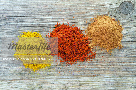 Three mounds of different spices from above