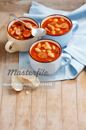 Beans with sausage and bacon in tomato sauce
