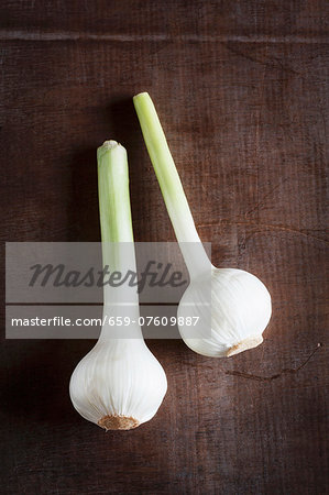 Fresh bulbs of garlic on a wooden surface