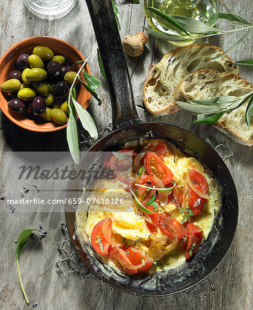 Tomato scrambled eggs with onions, black and green olives, olive oil, an olive spring, olive ciabatta and lavender